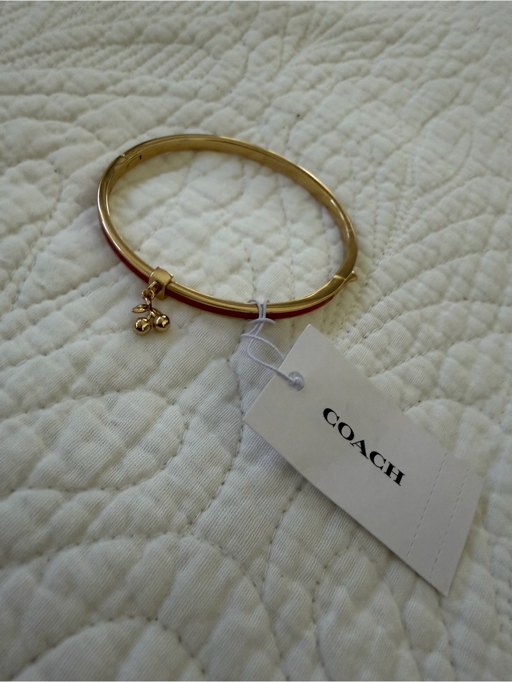 Coach Gold-Tone Bangle with Red Enamel Edge and Cherry Charm